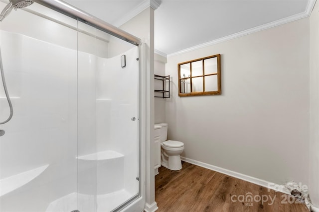 bathroom featuring walk in shower, crown molding, toilet, and hardwood / wood-style flooring