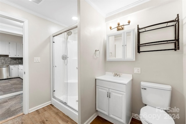 bathroom with hardwood / wood-style floors, a shower with shower door, ornamental molding, and vanity