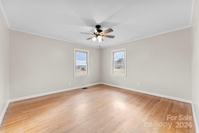 empty room featuring crown molding, ceiling fan, and light hardwood / wood-style floors