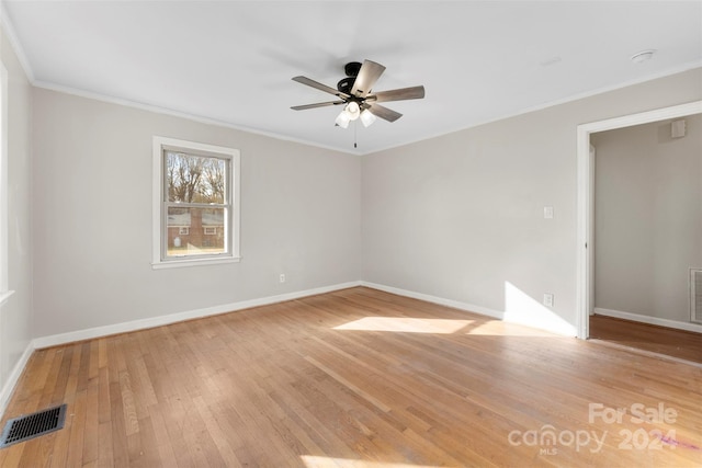 spare room featuring light hardwood / wood-style flooring, ceiling fan, and ornamental molding