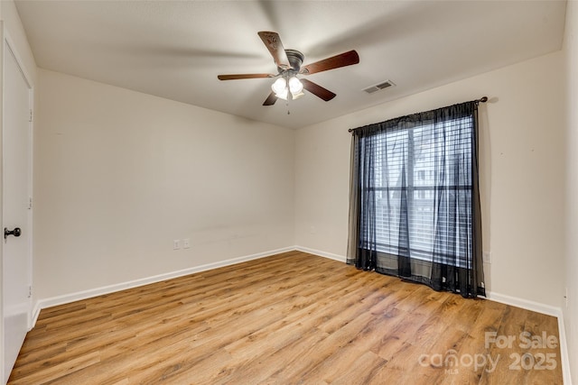 spare room with light hardwood / wood-style flooring and ceiling fan