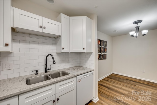 kitchen featuring dishwasher, decorative light fixtures, white cabinetry, and sink