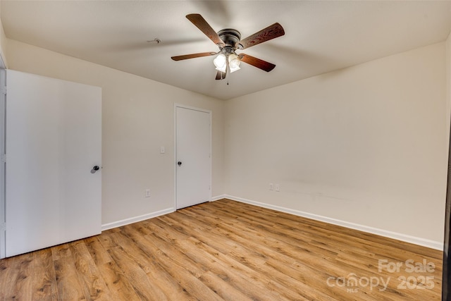 unfurnished room featuring ceiling fan and light wood-type flooring