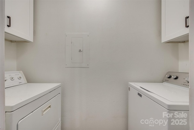 clothes washing area featuring cabinets, separate washer and dryer, and electric panel