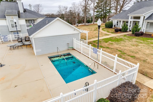 view of pool featuring a yard and a patio