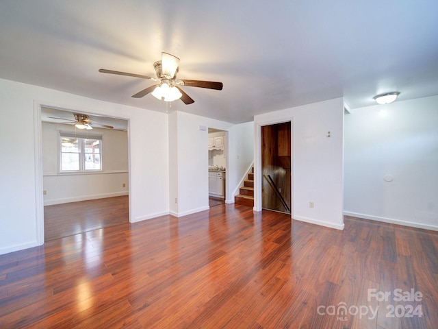 spare room with dark hardwood / wood-style floors and ceiling fan