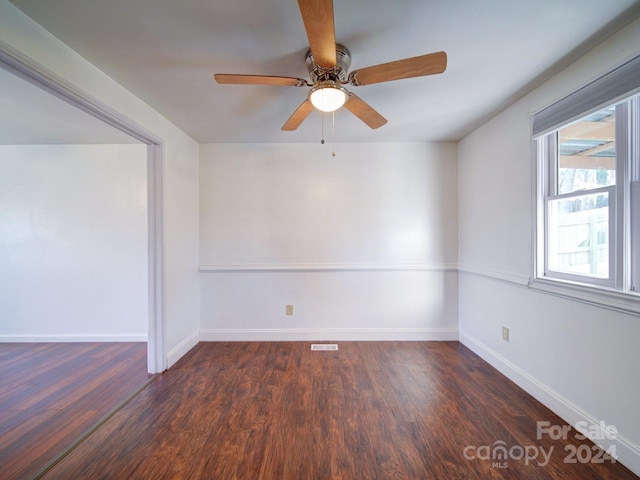 spare room with ceiling fan and dark wood-type flooring