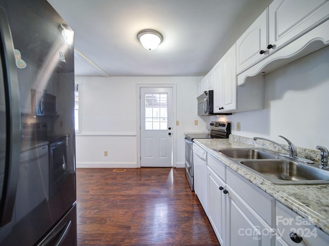 kitchen with stainless steel electric stove, sink, white cabinets, and dark wood-type flooring