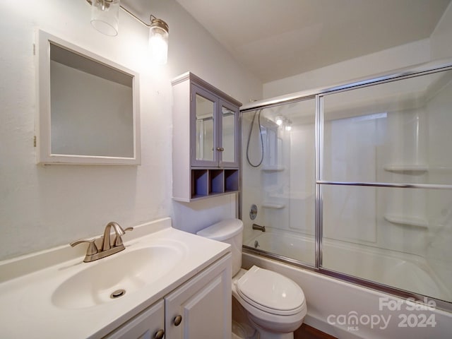 full bathroom with vanity, toilet, and enclosed tub / shower combo