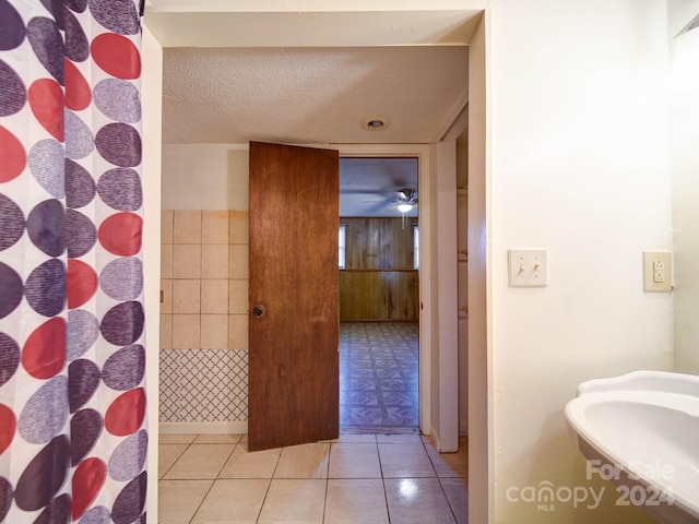 bathroom featuring sink, a textured ceiling, and tile patterned flooring