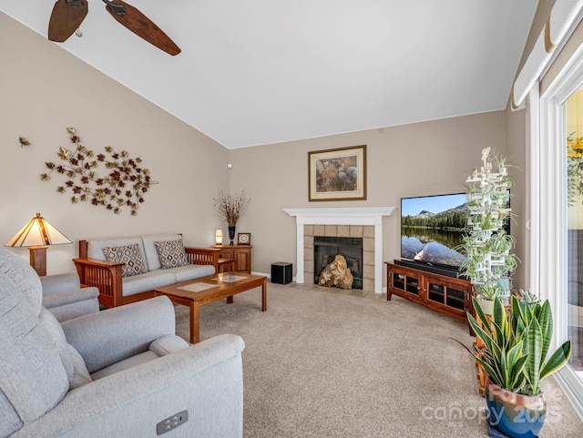 carpeted living room featuring ceiling fan, lofted ceiling, and a fireplace