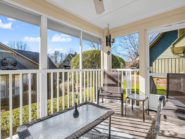 sunroom featuring ceiling fan and a wealth of natural light