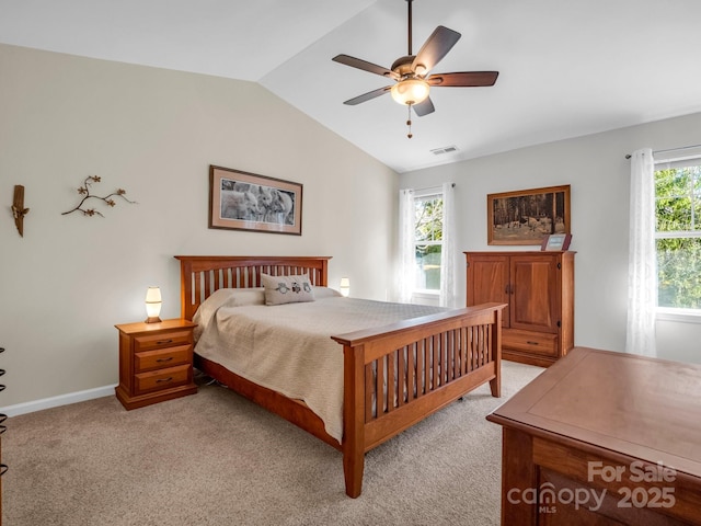 carpeted bedroom with ceiling fan, lofted ceiling, and multiple windows