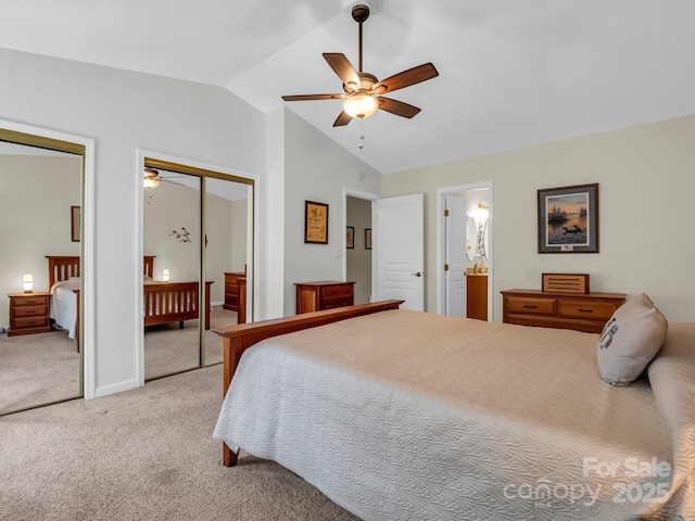 bedroom featuring carpet floors, ensuite bathroom, vaulted ceiling, and ceiling fan