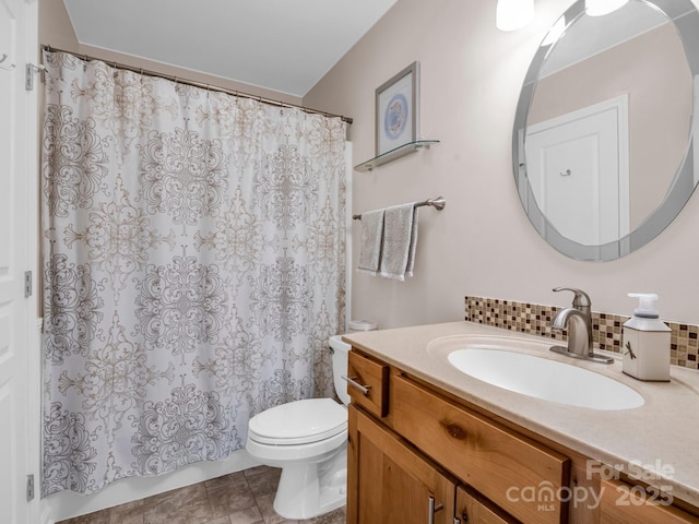 bathroom with vanity, toilet, and backsplash