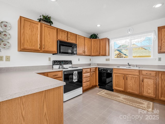 kitchen with a textured ceiling, sink, and black appliances