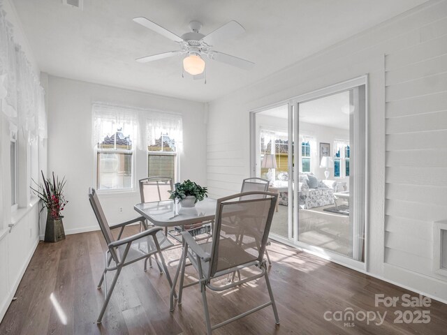 dining room featuring ceiling fan, dark hardwood / wood-style flooring, and a healthy amount of sunlight