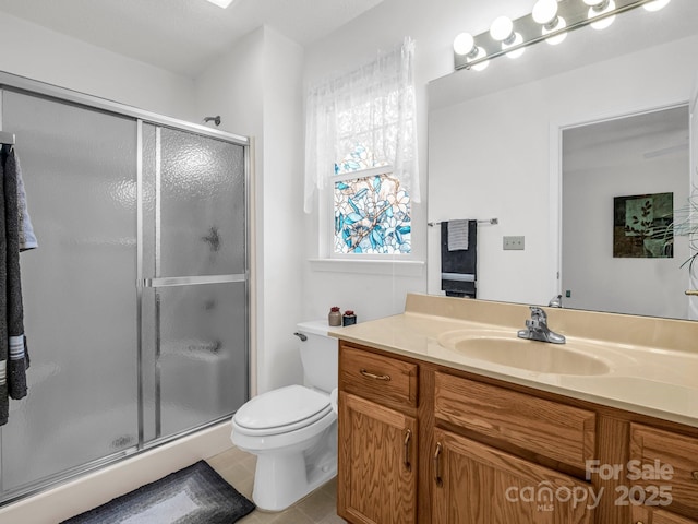 bathroom featuring toilet, vanity, and walk in shower