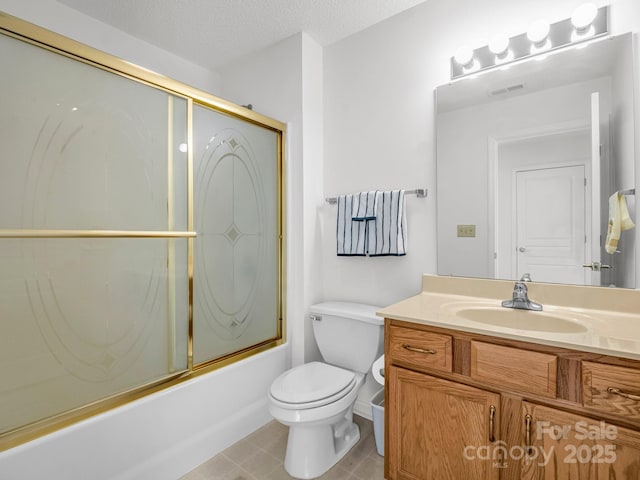 full bathroom with vanity, tile patterned floors, toilet, enclosed tub / shower combo, and a textured ceiling