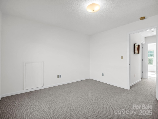 empty room featuring carpet flooring and a textured ceiling