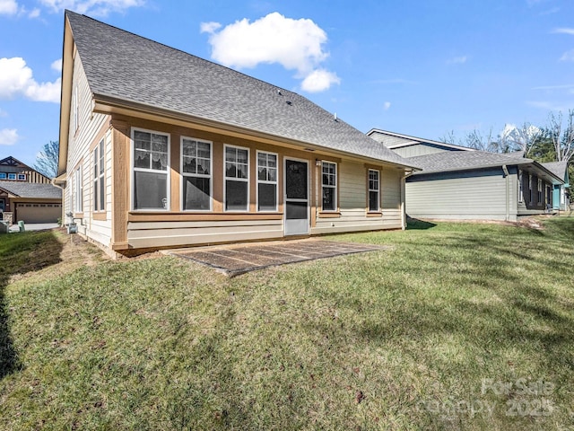 rear view of property with a yard