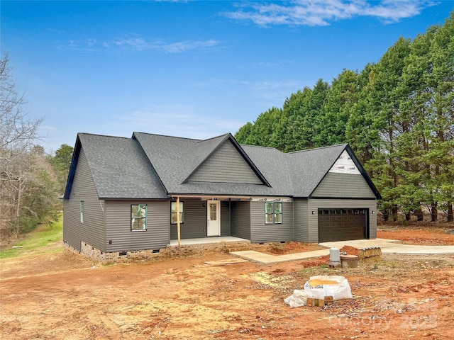 view of front of property featuring a porch and a garage