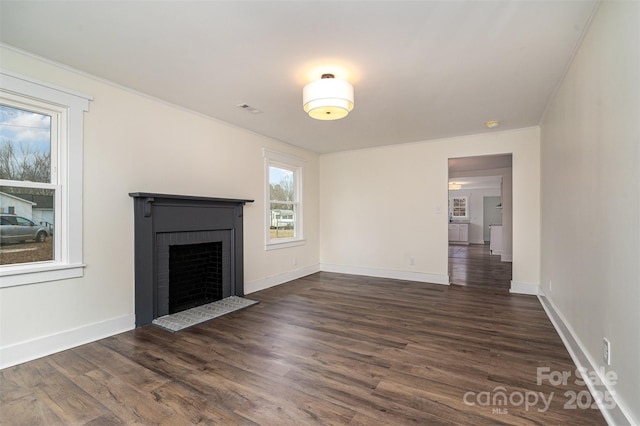 unfurnished living room featuring dark wood-type flooring and a fireplace