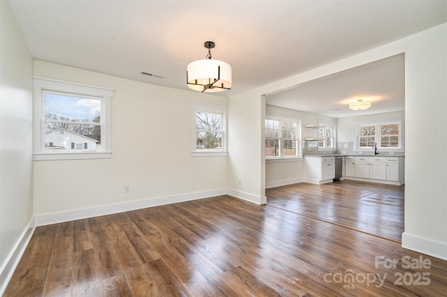 unfurnished dining area featuring dark hardwood / wood-style flooring and sink