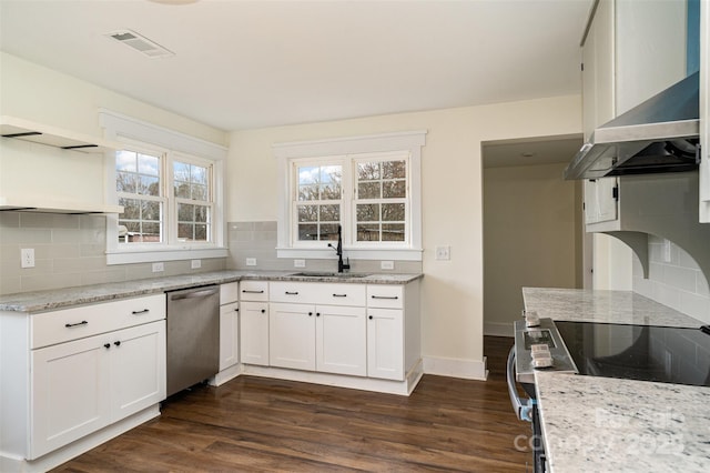 kitchen featuring white cabinetry, sink, light stone counters, and appliances with stainless steel finishes