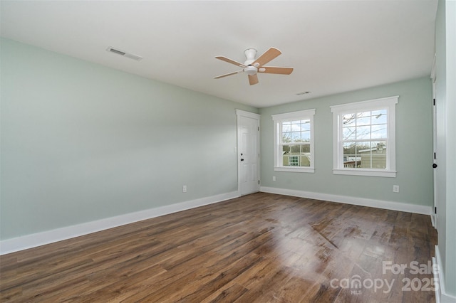 empty room with dark wood-type flooring and ceiling fan