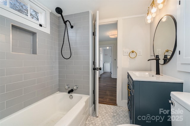 full bathroom with tiled shower / bath combo, vanity, and toilet