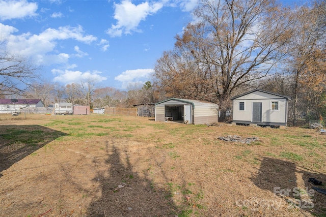 view of yard with an outdoor structure and a carport