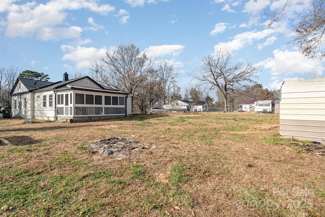 view of yard featuring a sunroom