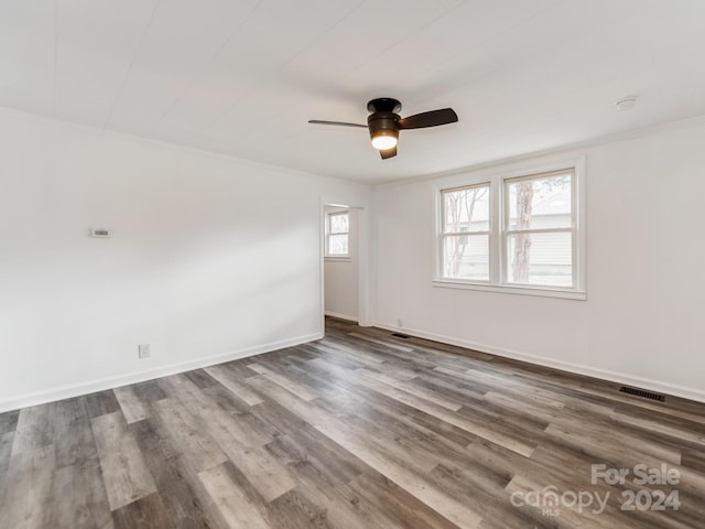 spare room with ceiling fan, hardwood / wood-style floors, and crown molding