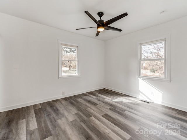 unfurnished room with hardwood / wood-style flooring and ceiling fan