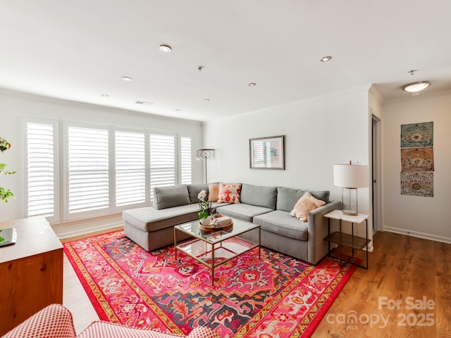 living room featuring crown molding, a wealth of natural light, and wood-type flooring