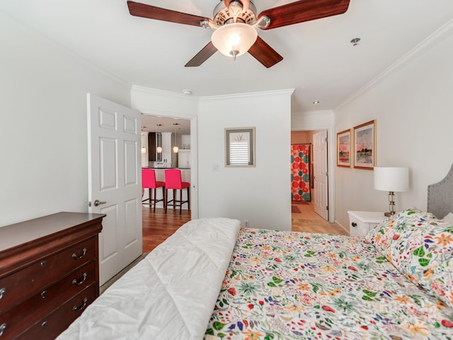 bedroom featuring ceiling fan, light hardwood / wood-style floors, and crown molding