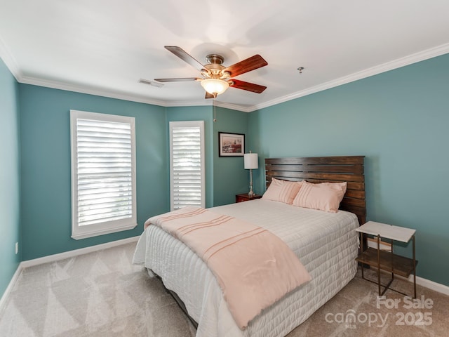 carpeted bedroom with ceiling fan and ornamental molding