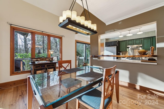 dining room with light hardwood / wood-style floors and ornamental molding