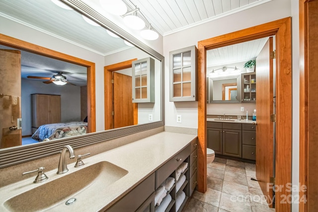 bathroom with ceiling fan, wooden ceiling, toilet, vanity, and ornamental molding