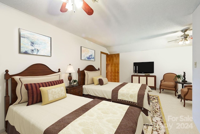 bedroom featuring a textured ceiling, carpet floors, vaulted ceiling, and ceiling fan