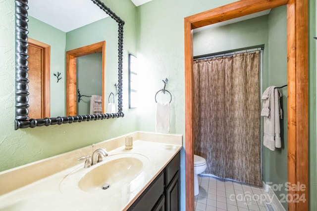 bathroom featuring tile patterned floors, vanity, and toilet