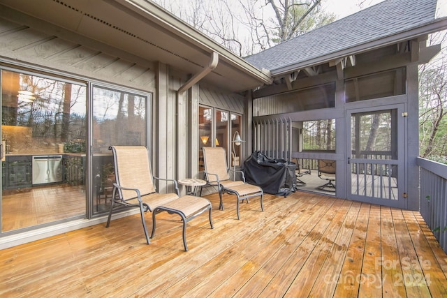 wooden terrace featuring a grill