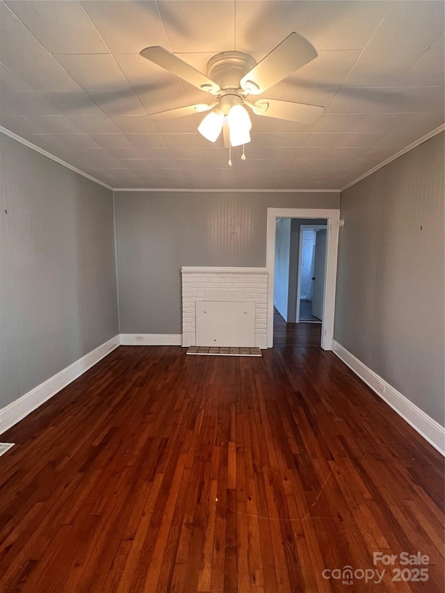 empty room with dark wood-type flooring, ornamental molding, and ceiling fan