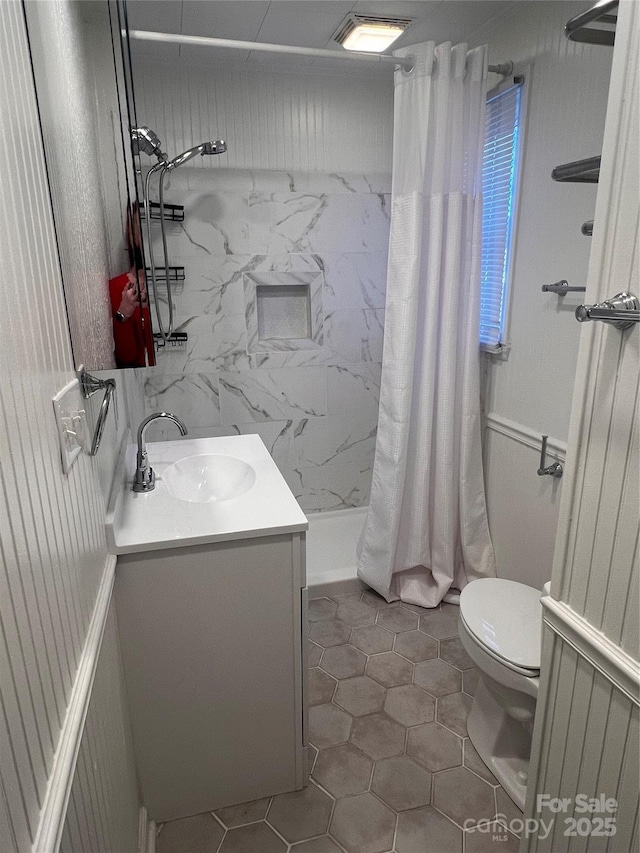 bathroom with toilet, vanity, tile patterned floors, and a shower with shower curtain