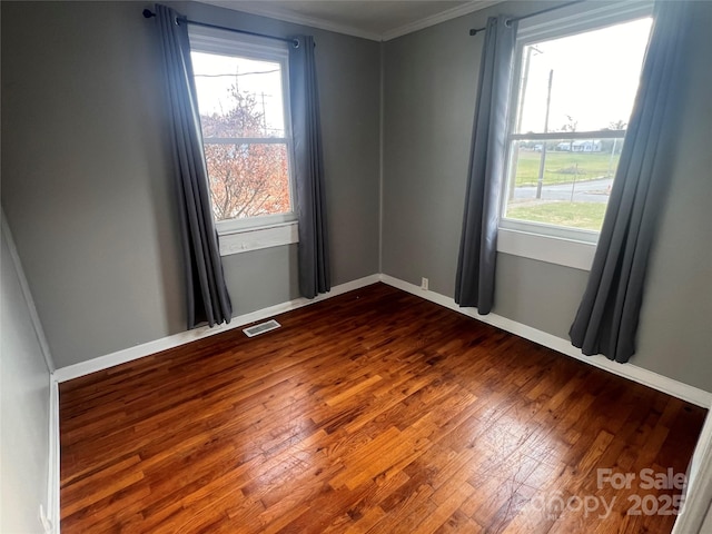 unfurnished room featuring crown molding and dark hardwood / wood-style flooring