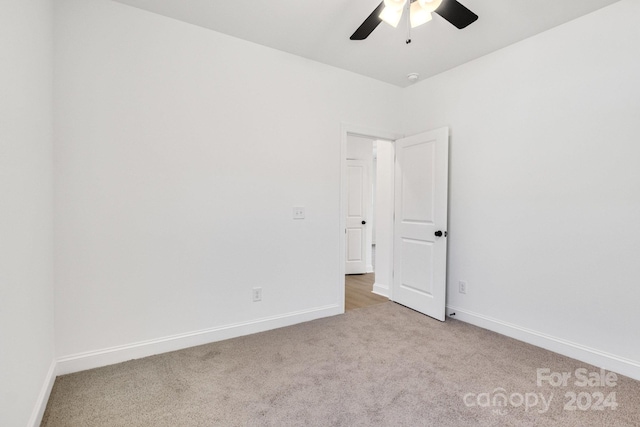 empty room with light colored carpet and ceiling fan