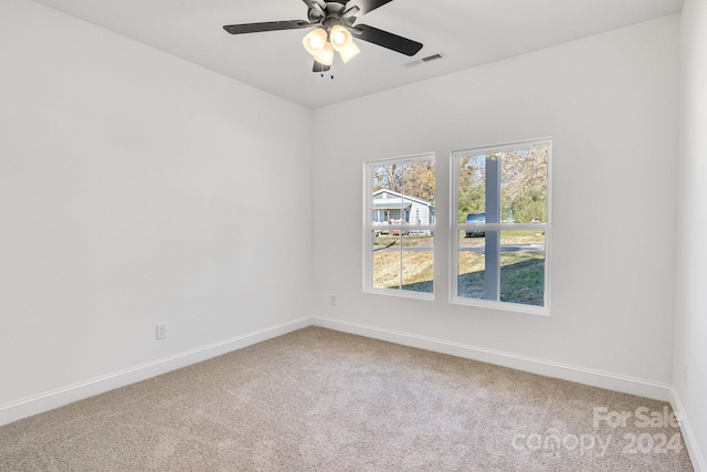 carpeted spare room with ceiling fan