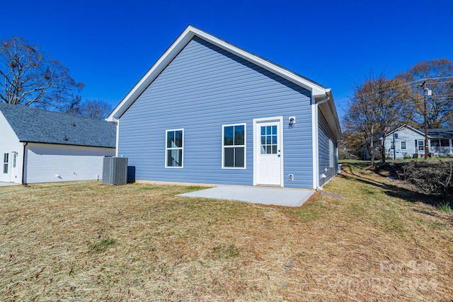 back of property featuring a yard, a patio area, and central air condition unit