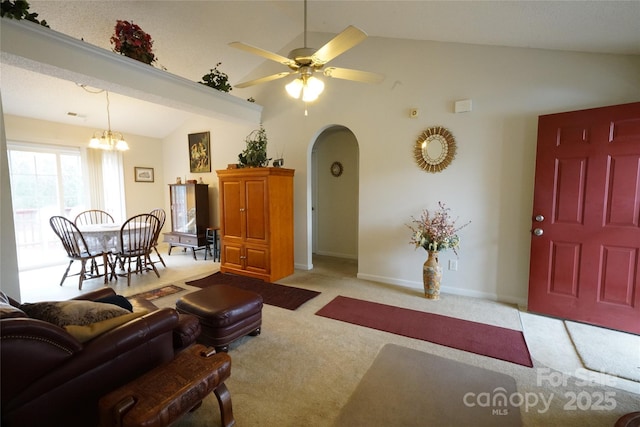 living room with light carpet, lofted ceiling, and ceiling fan with notable chandelier